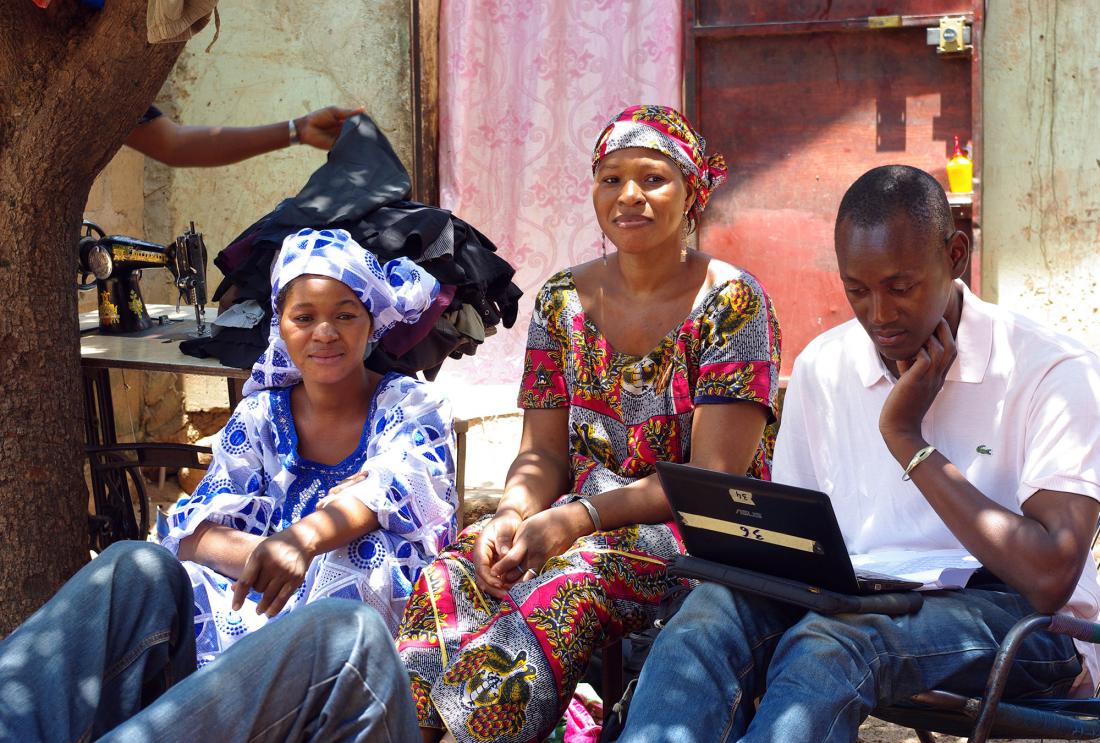 women in Mali discuss survey questions with an enumerator