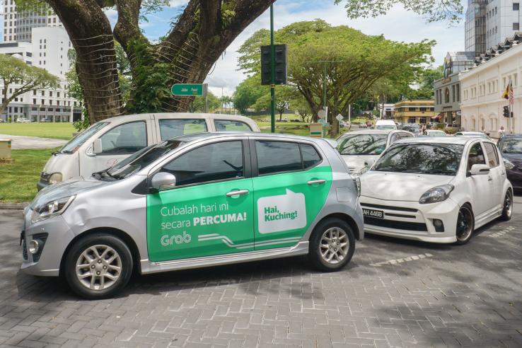 Car with Grab advertisement
