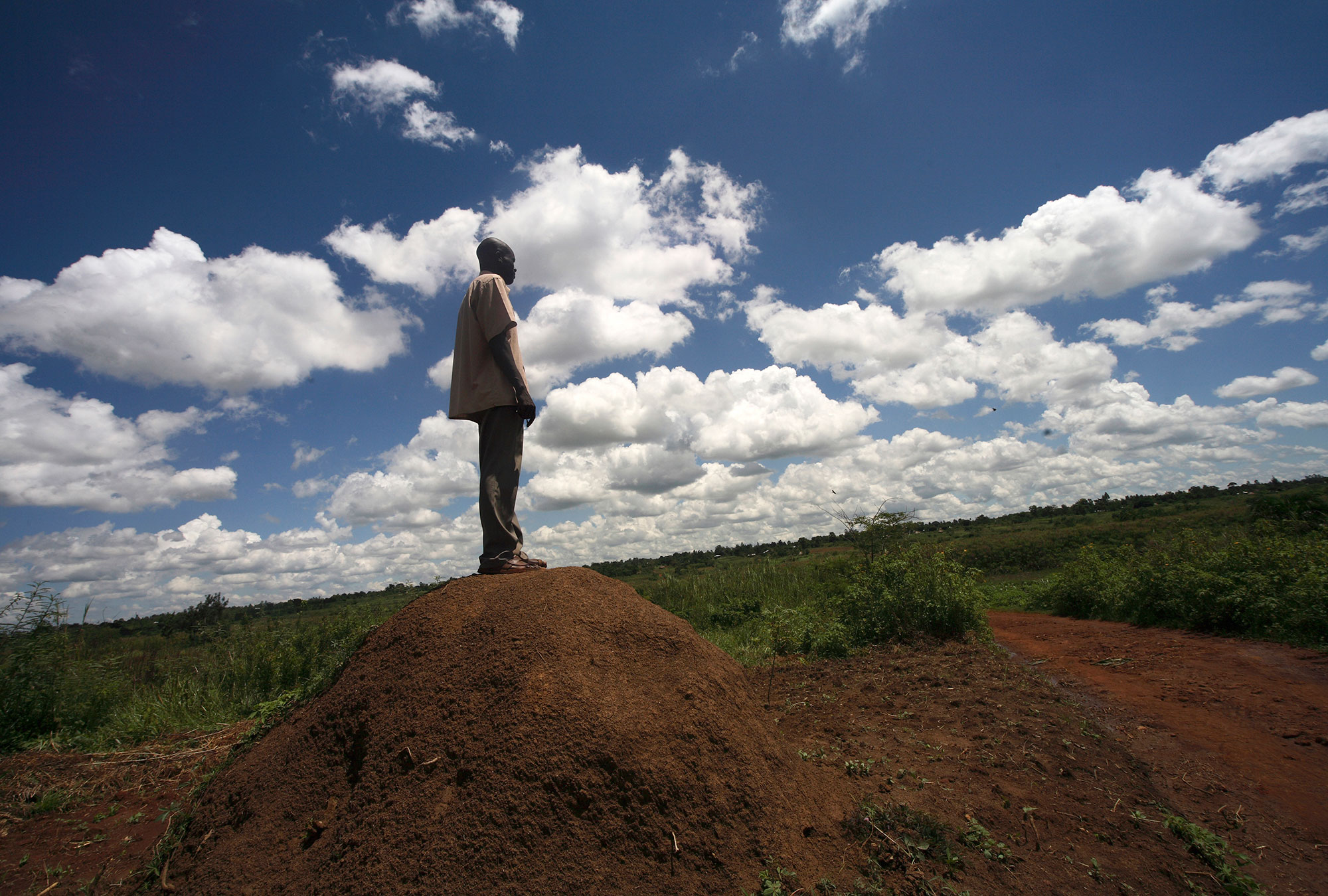 A man is looking out over the land in Kenya.