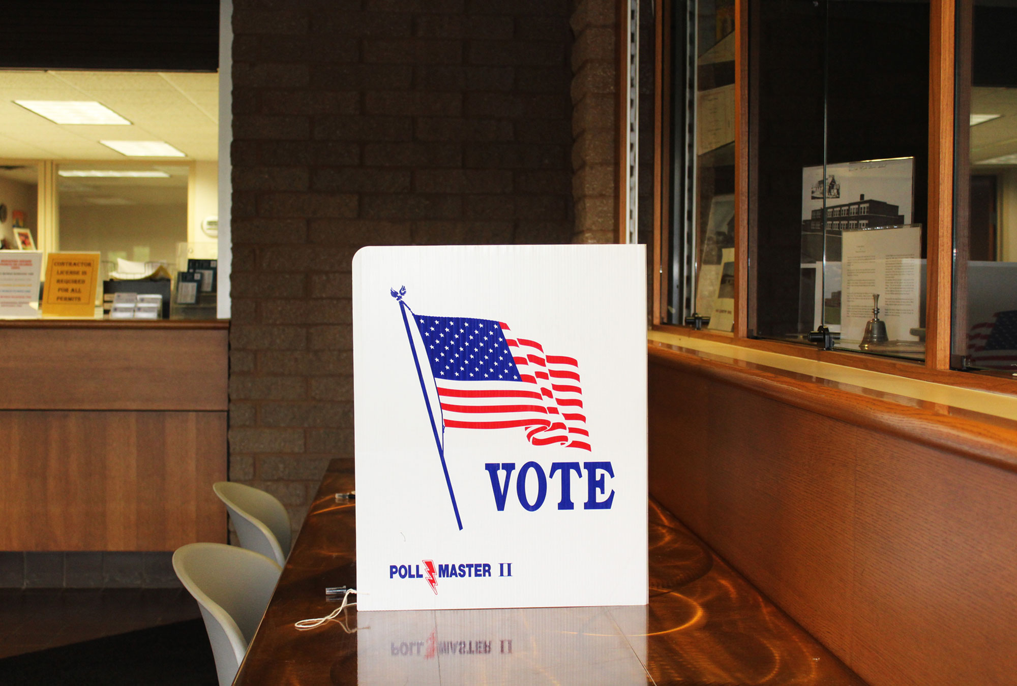 Polling location with privacy screen reading "Vote"