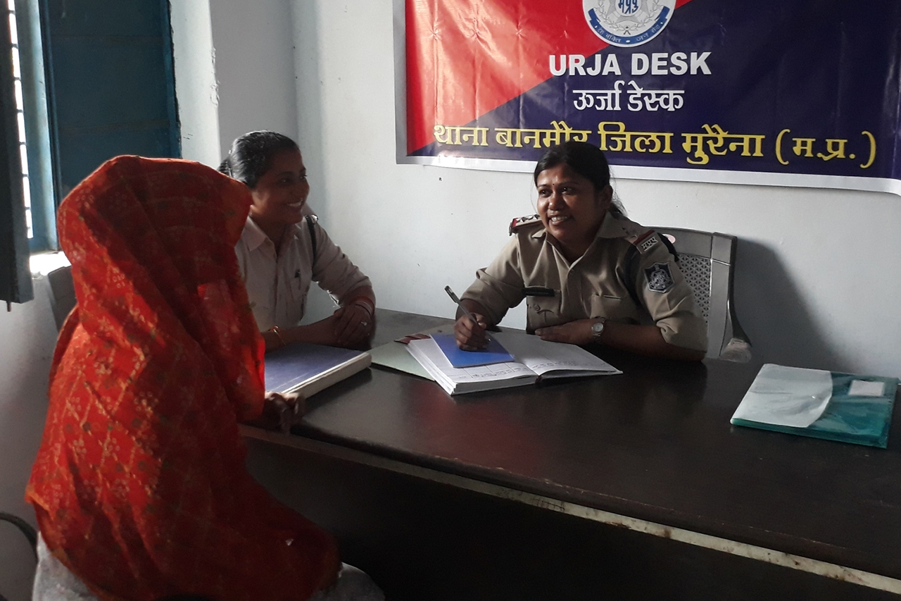 A woman speaks to a female officer