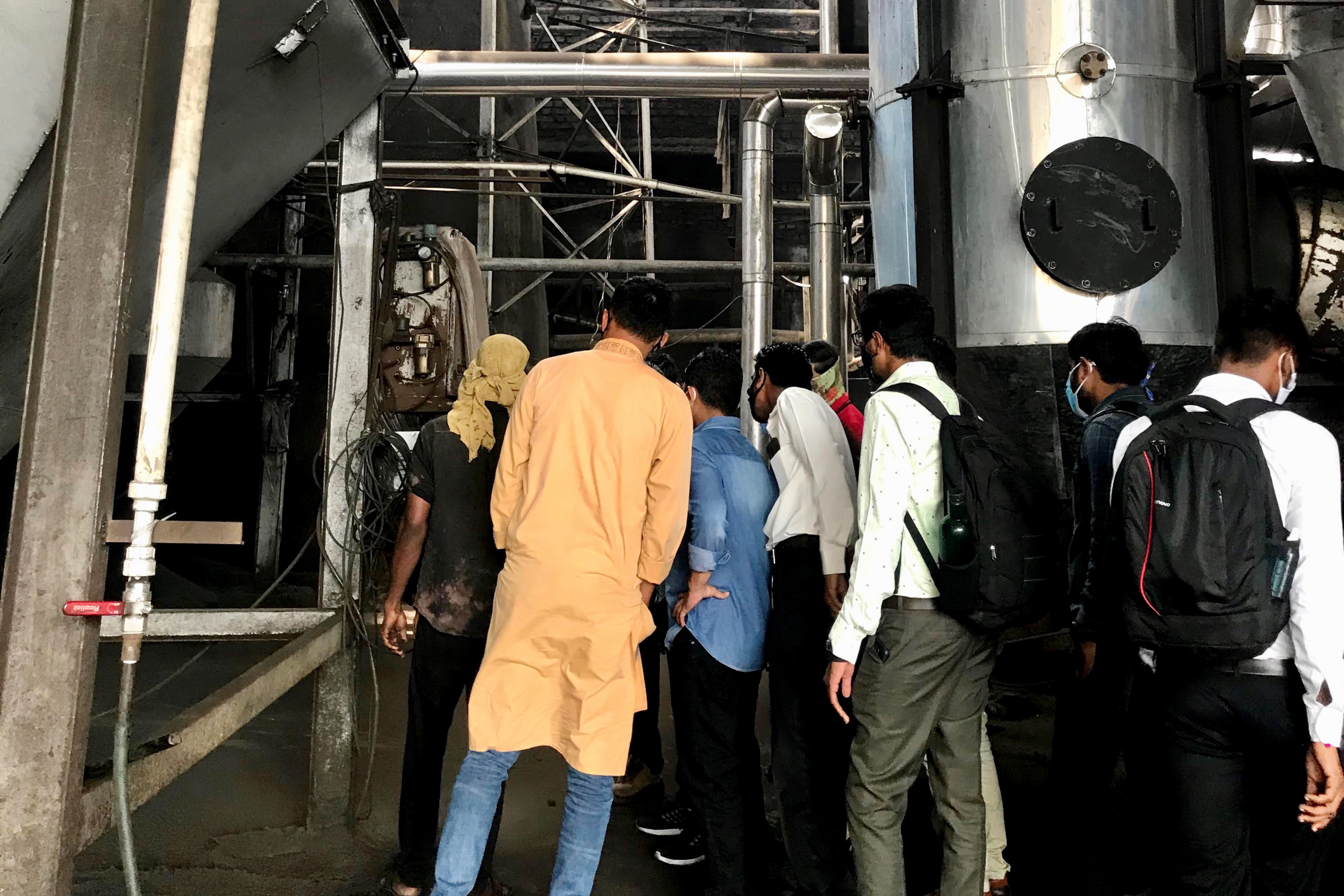 People standing outside factory 