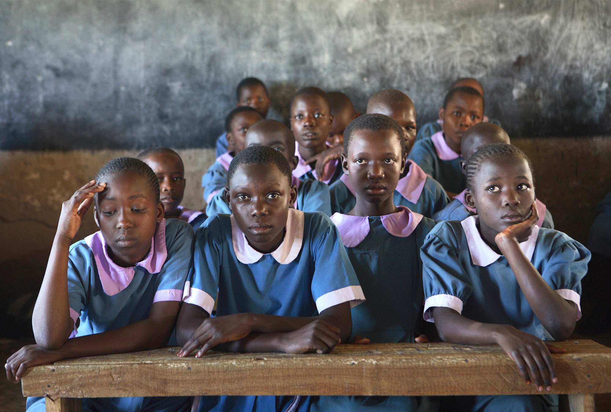 Girls in school uniforms sit in class
