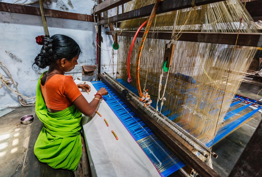 woman using loom