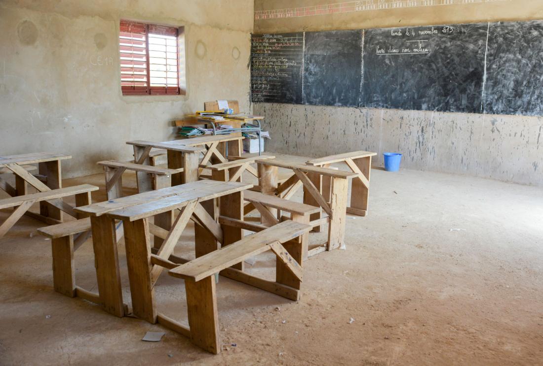 Empty room with wood desks and chalkboard