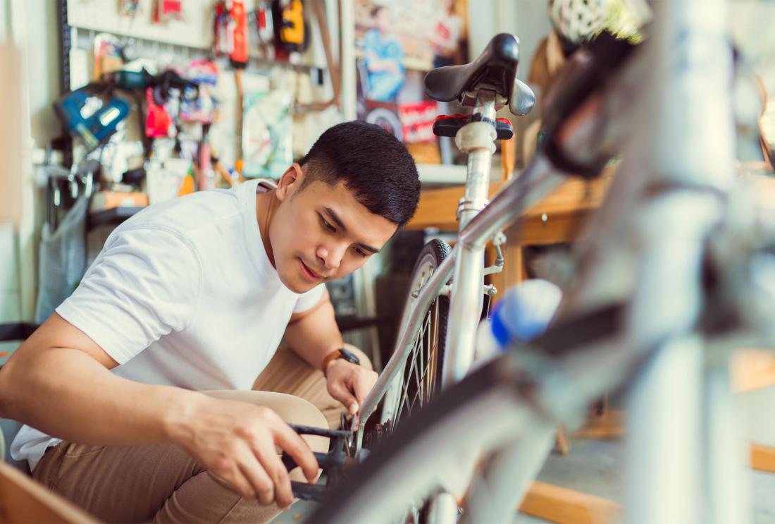 Young man repairing a bike