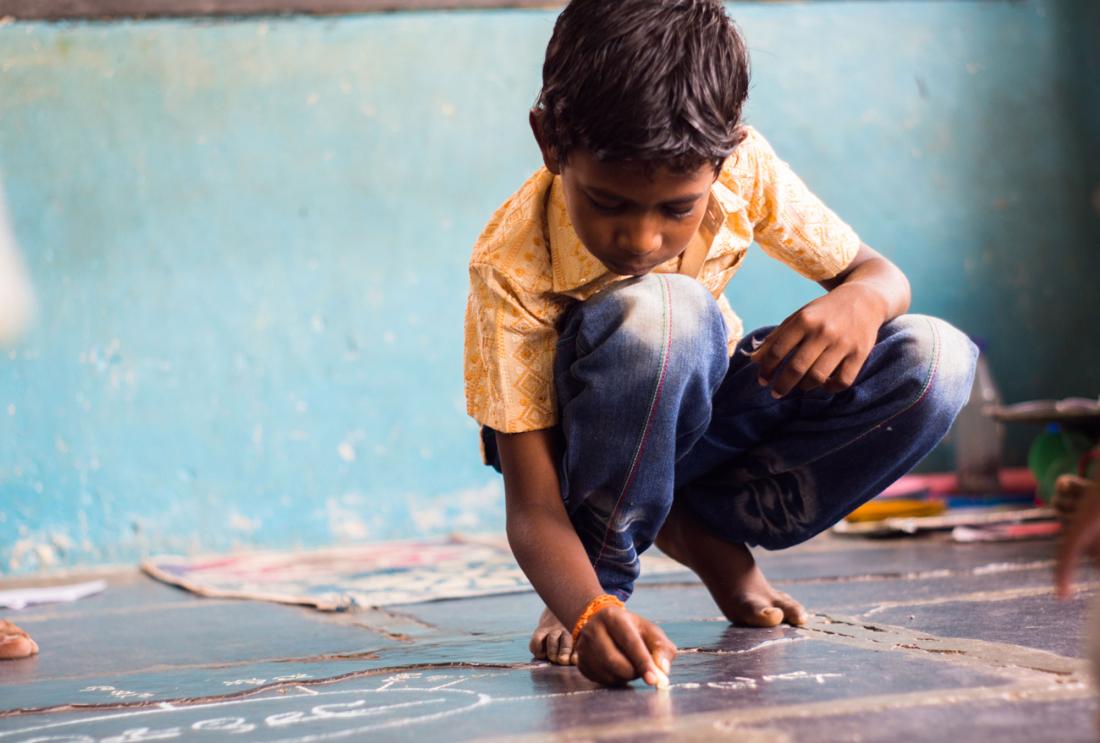 Indian boy on school room floor