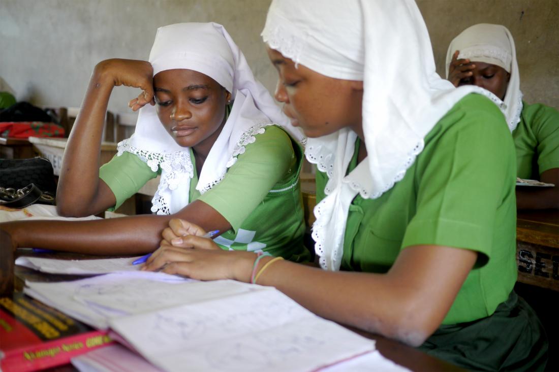 two female students reading a book