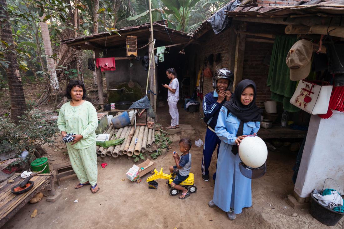 A family stands outside their home