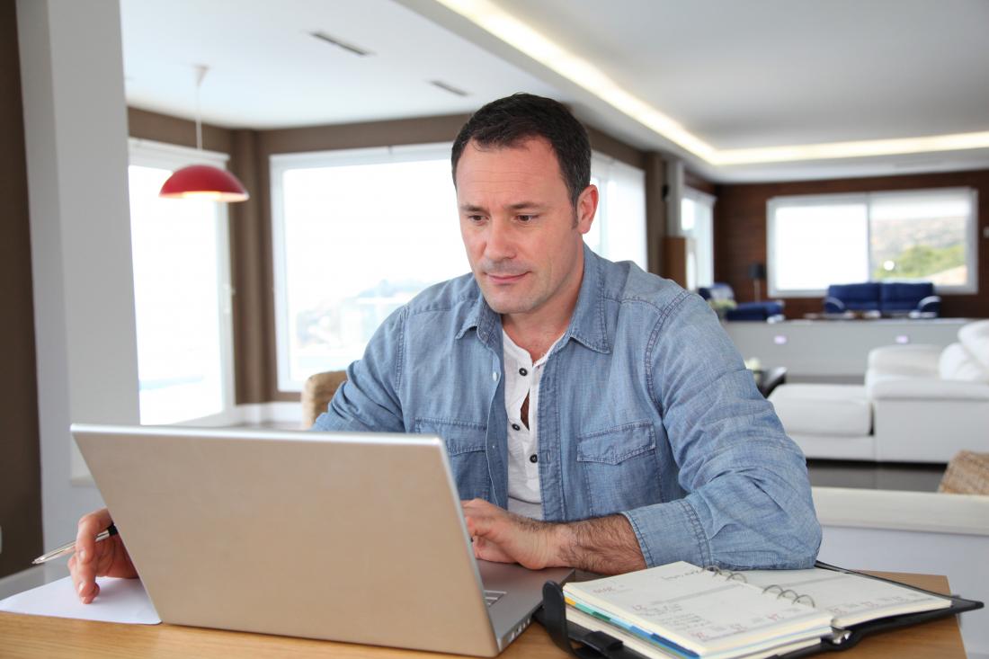 caucasian man working on laptop