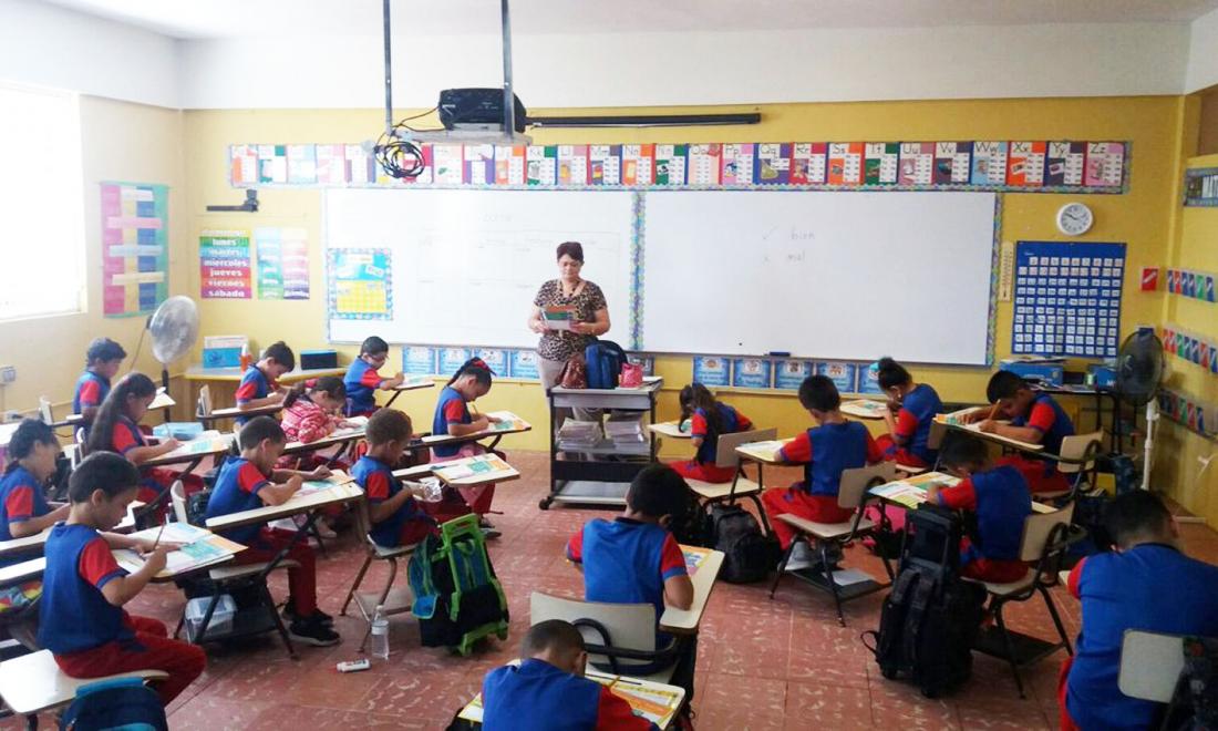 Young students do schoolwork in a classroom in Puerto Rico
