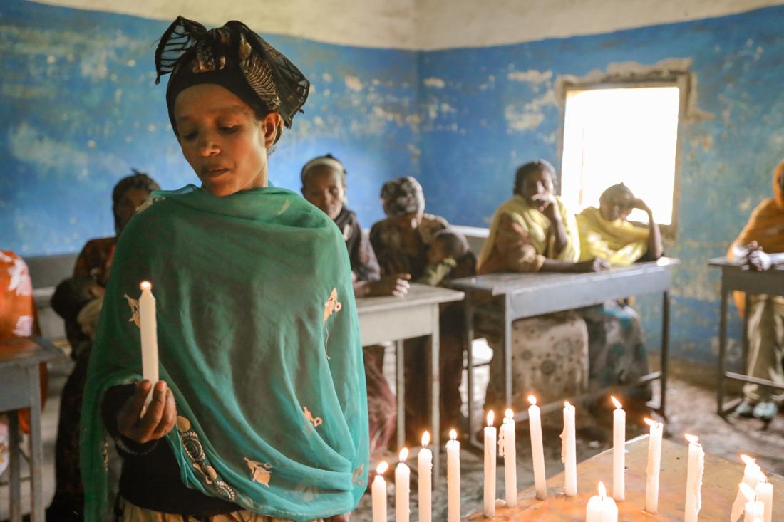 group of Ethiopian women lighting candles
