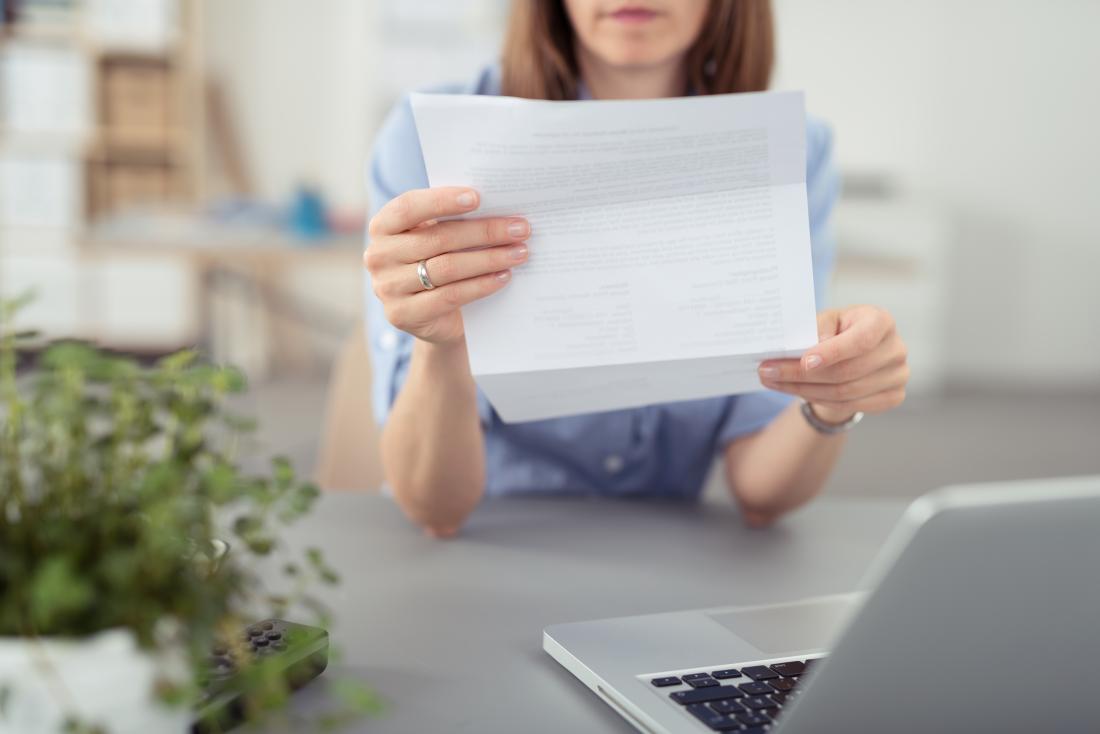 close up of woman reading letter