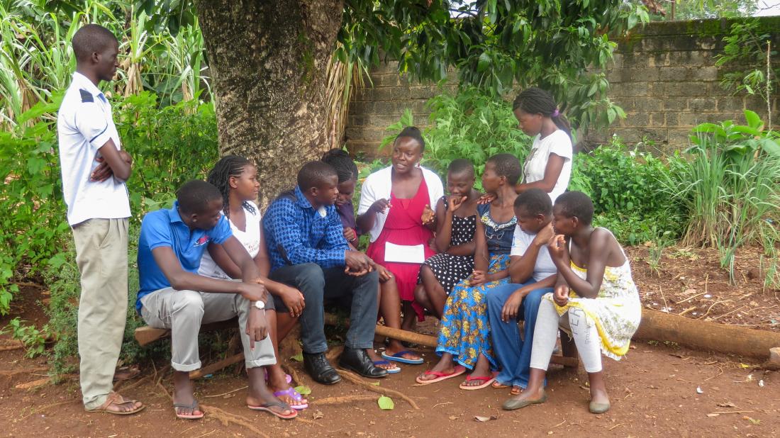 A Community Health Worker addresses a group of people in Kenya.