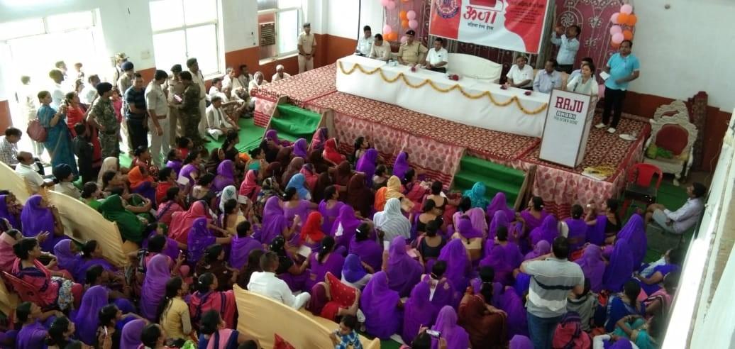 Women attend a community outreach session on women's help desks.