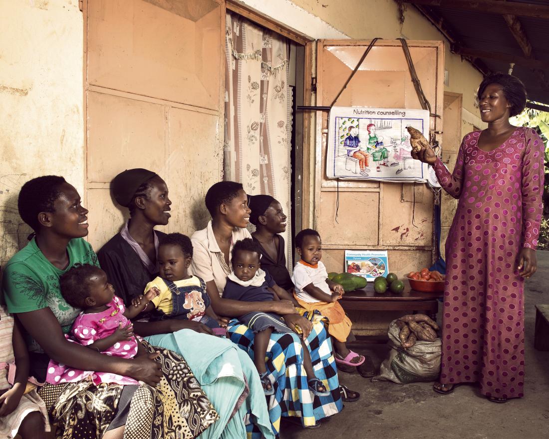 A Community Health Worker teaches nutrition to members of local households
