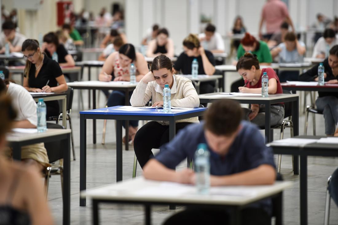 Image of students taking an exam at their desks in Bucharest, Romania.