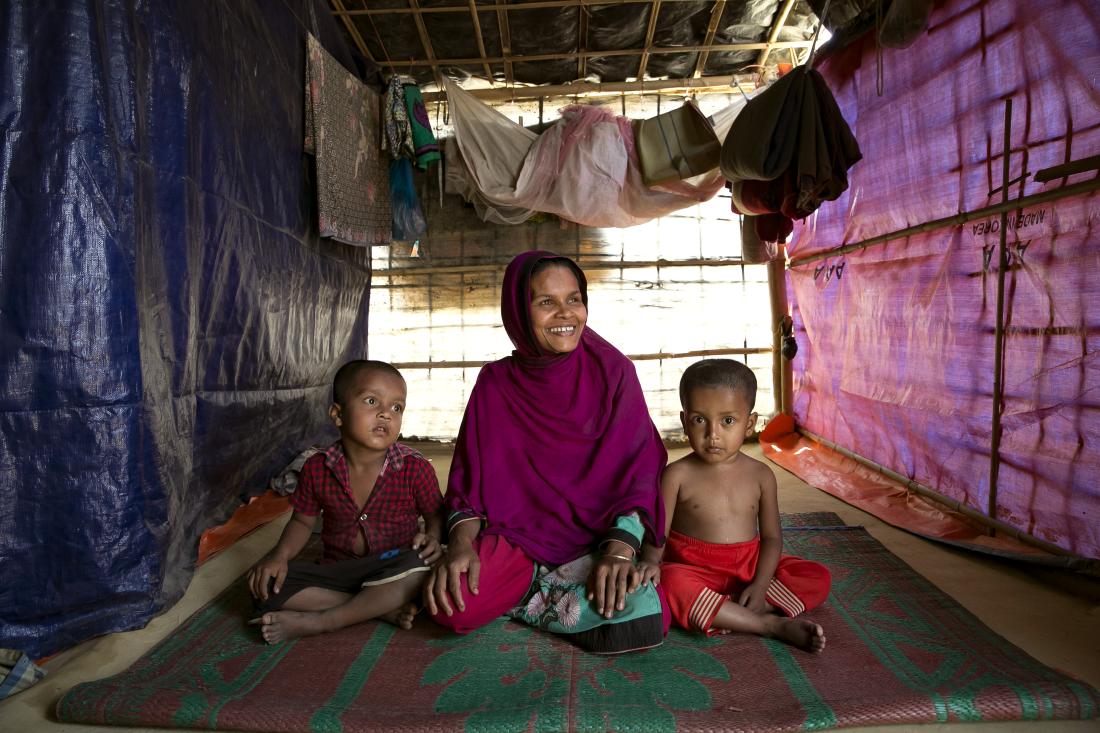 A Rohingya woman sits with her two children in Balukhali refugee camp in Cox's Bazar, Bangladesh.