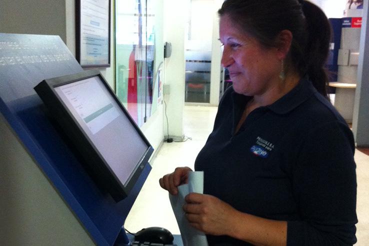 A woman smiling in front of the pension simulation kiosk