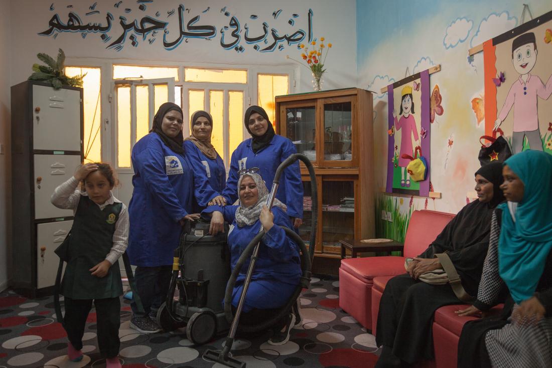 A group of female plumbers enter a school to fix a water tank in Jordan.