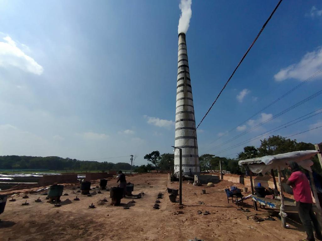 Smoke emitting from tall kiln chimney