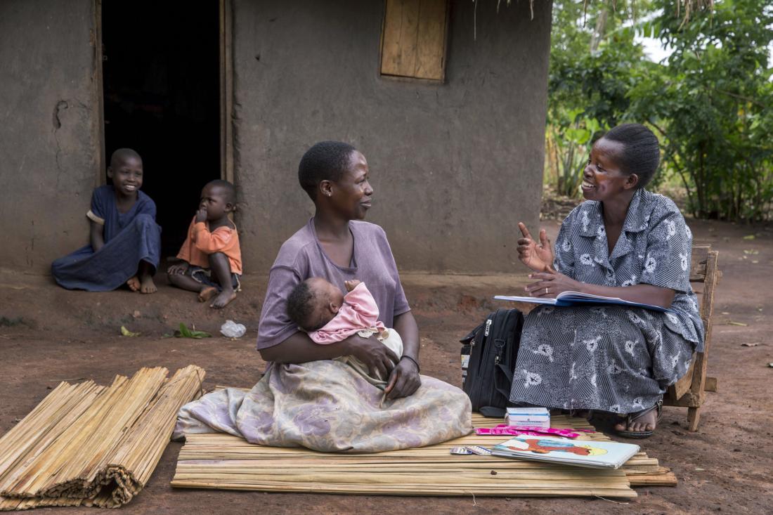Women discusses with community health worker.