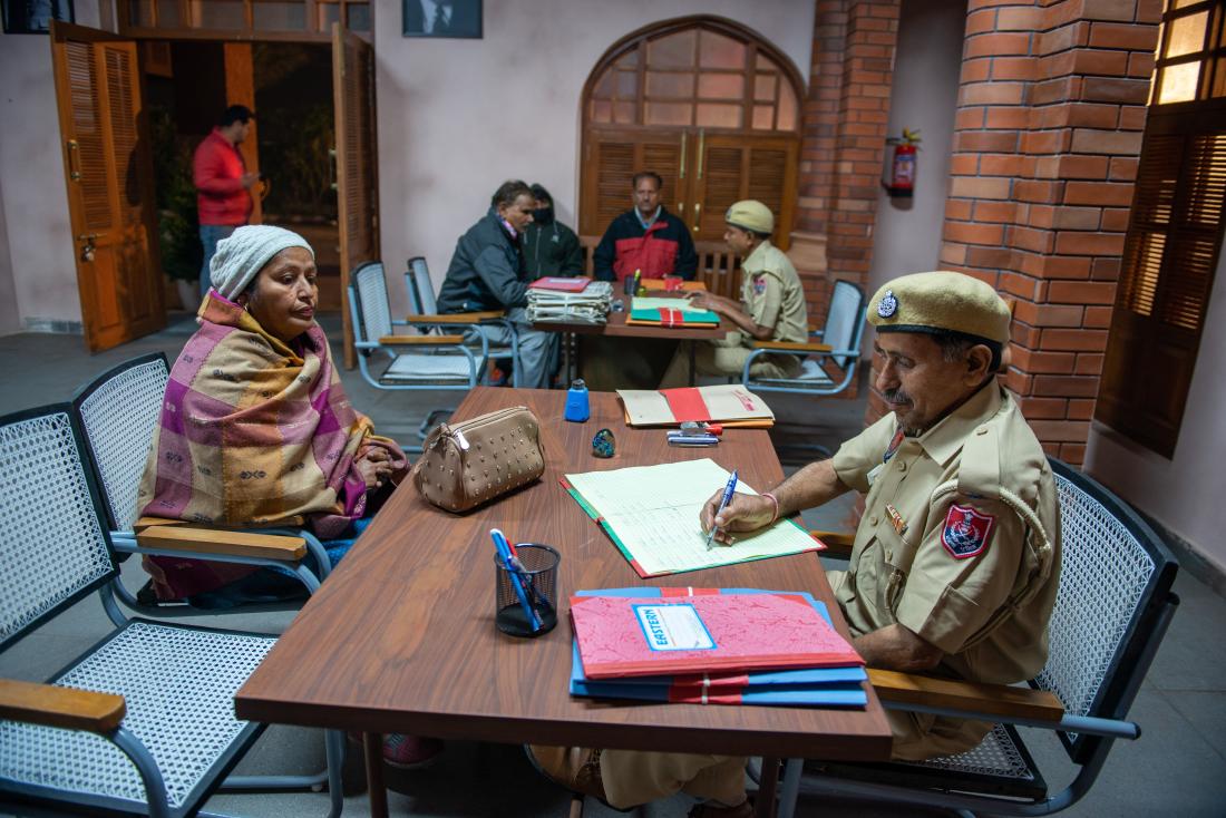 Woman at desk with police officer