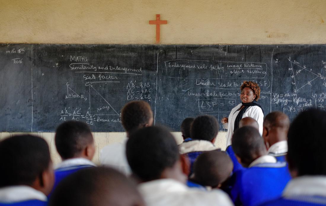 Teacher teaching students in a classroom in Rwanda
