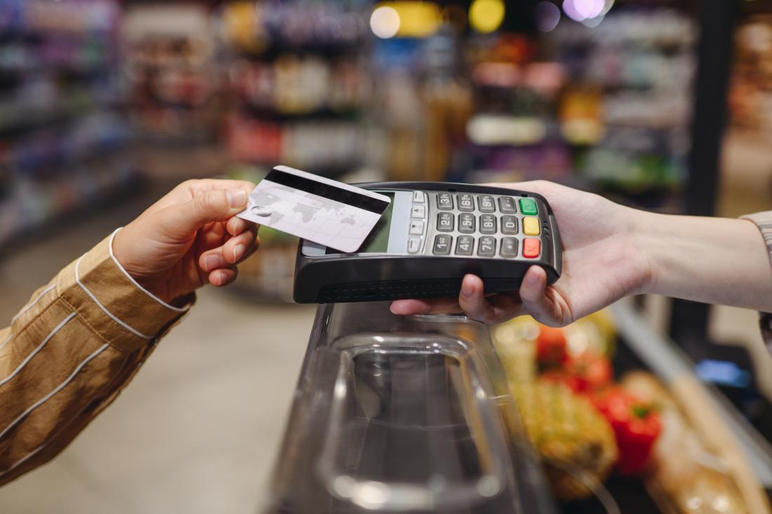 Customer uses credit card to pay for goods in grocery store in Mexico