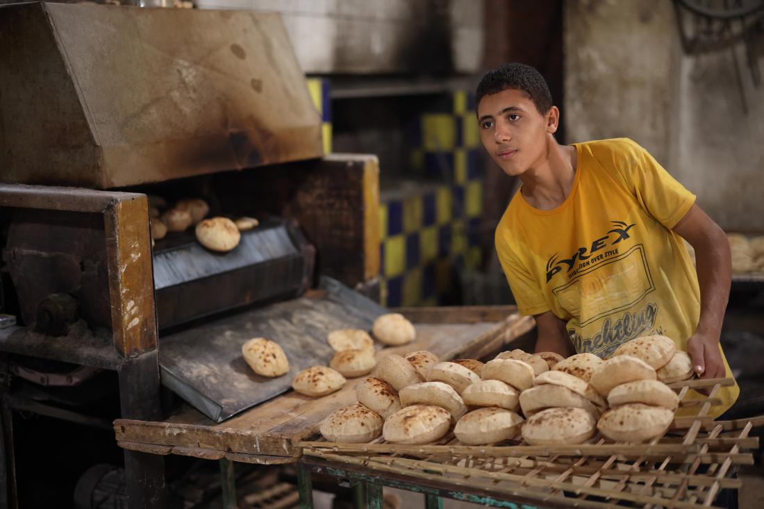 A young man works in a bakery in Egypt.