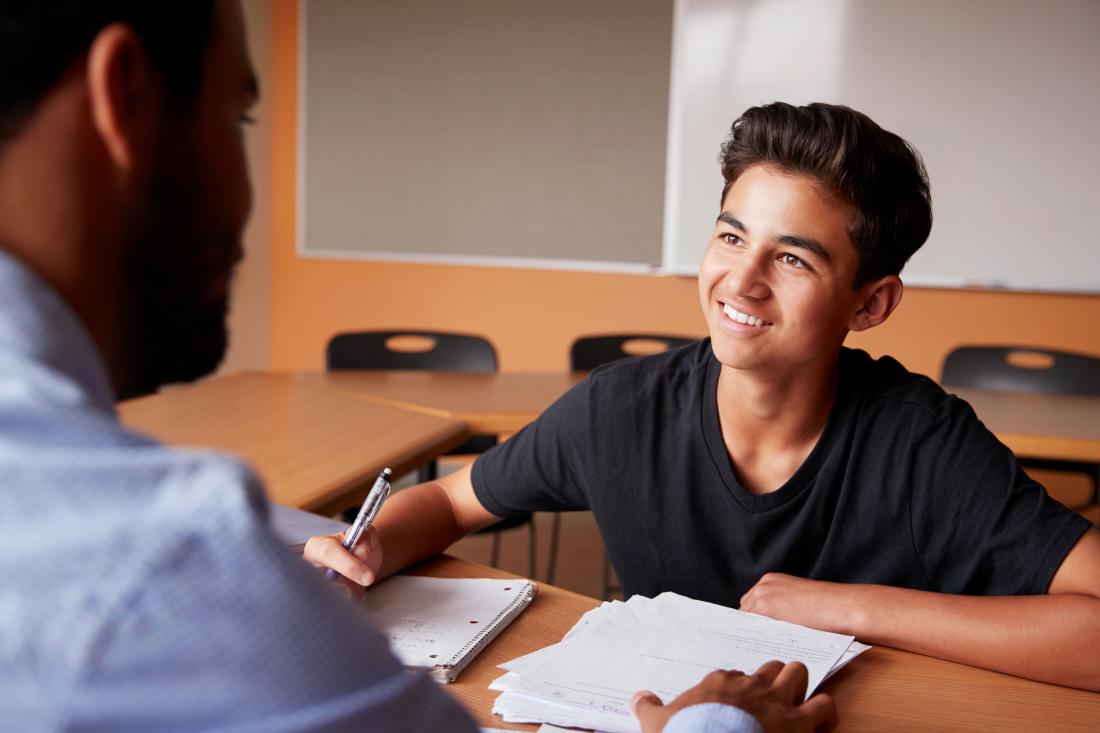 Male tutoring high school boy wearing black t-shirt in Mexico
