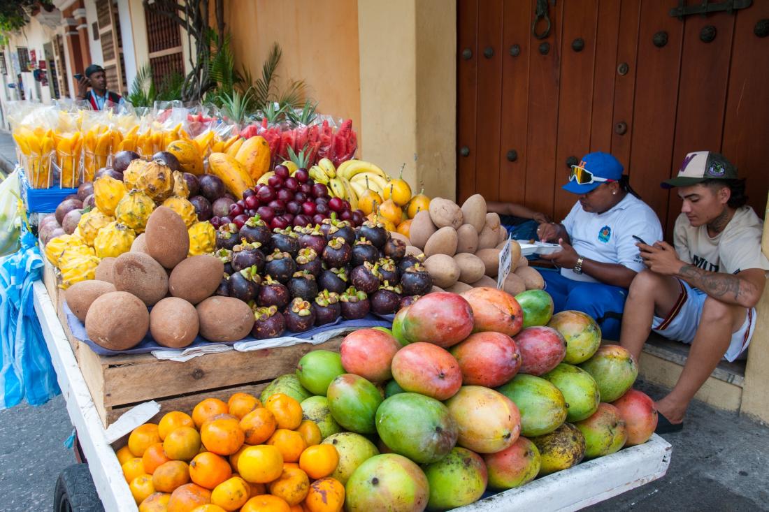 Fruit vendors staying connected to groups on their phones in Chile