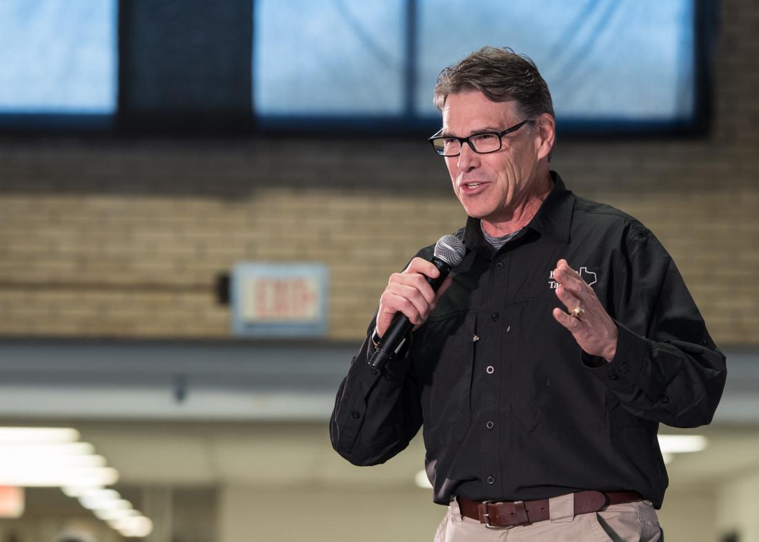 Televised campaign event with Rick Perry speaking into microphone in the United States