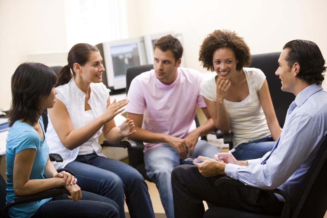 Men and women engage in group discussion. 