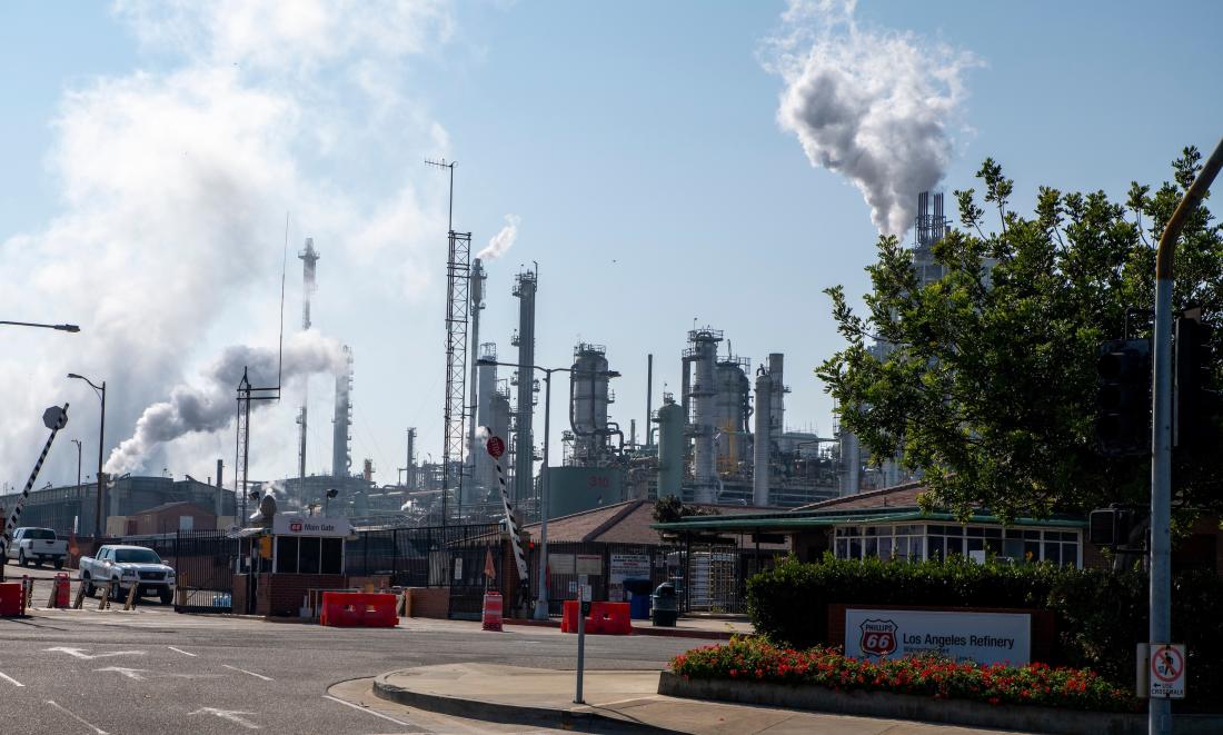 A factory participating in cap-and-trade program emits pollutants and emissions in the United States