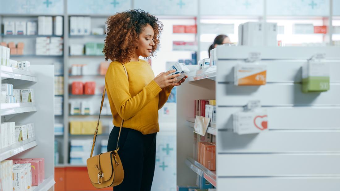 Woman looks at items in a pharmacy.