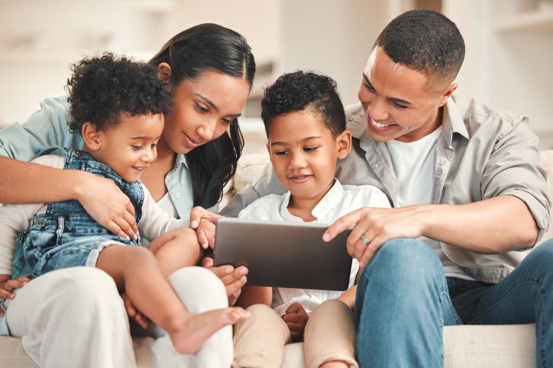 Parents and children engaging with educational program on tablet in the United States