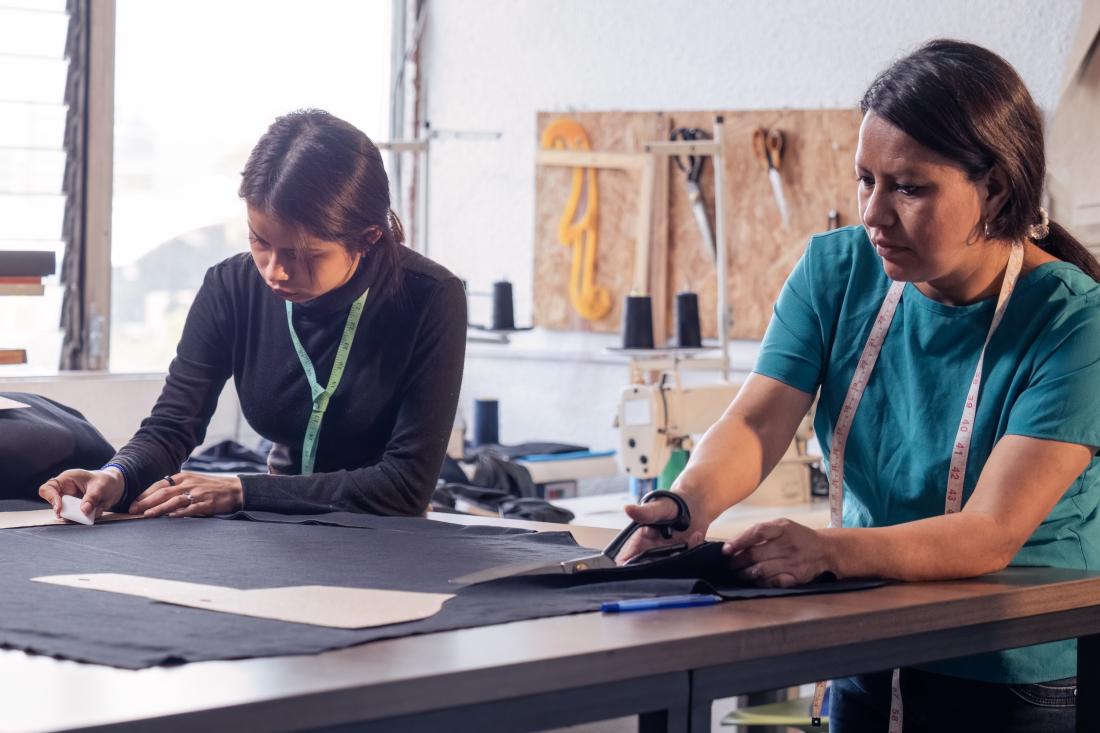Two female entrepreneurs working on sewing projects in Colombia