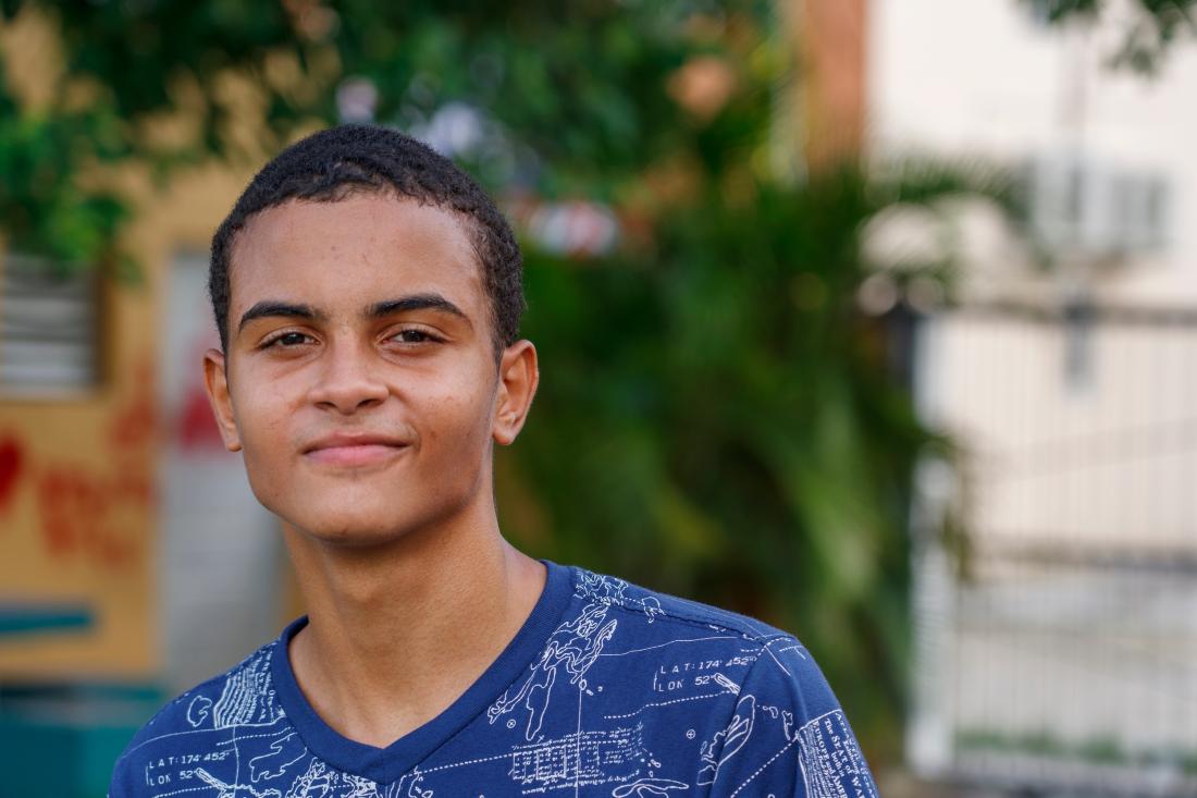 Male teenage student walks home from school in the Dominican Republic