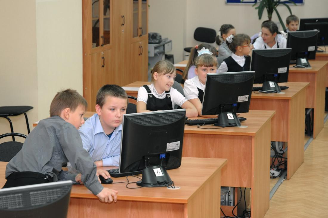 Young children in classroom going through computer-assisted learning in Russia