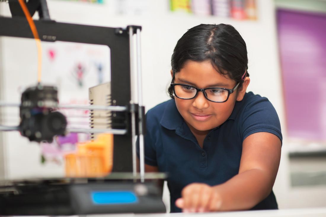 A young female student learning as she works on task in school laboratory in the United States
