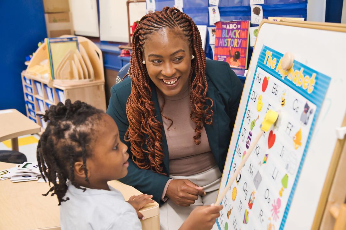 A Black female teacher engages with effective teaching in literacy activity in the United States