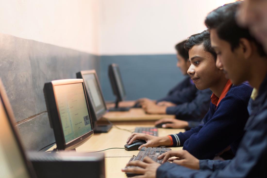 Students working on computers in India.