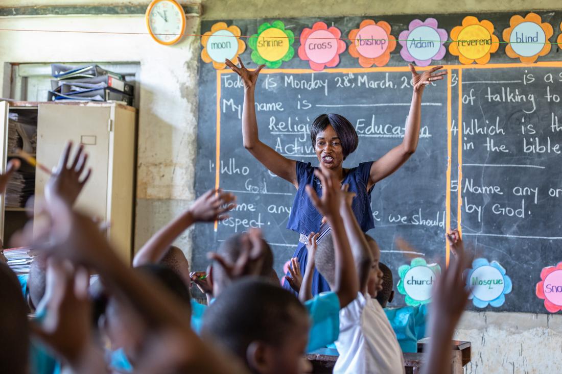 Teacher standing in front of classroom of students 