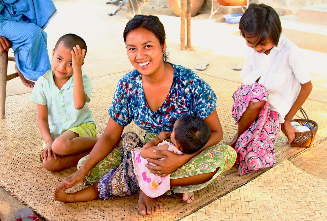 Smiling woman with three children