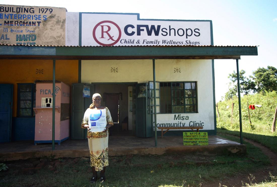 Woman standing in front of store called "CFW Shops"