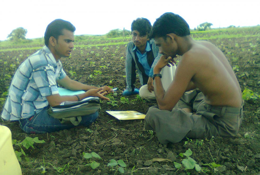 Photo of people sitting in field