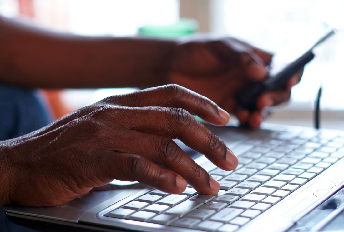 Hands typing on a computer