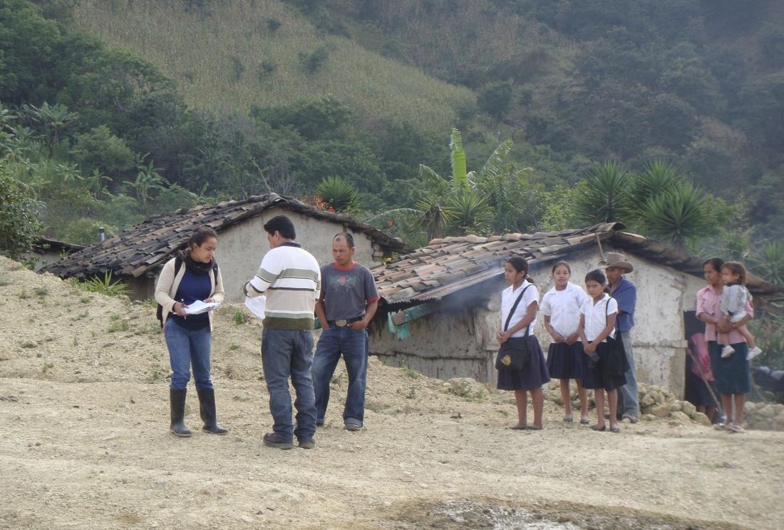 Villagers gather around a survey team in Lempira, Honduras.