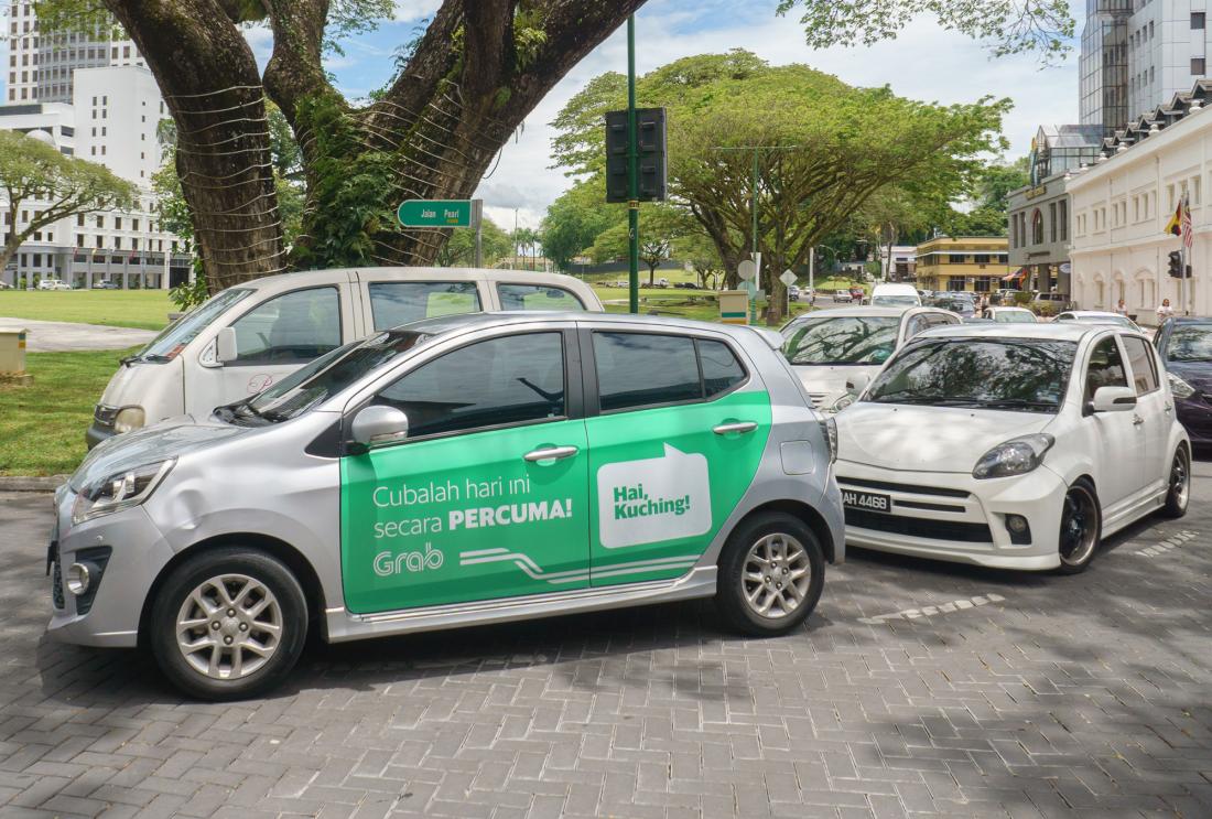 Car with Grab advertisement